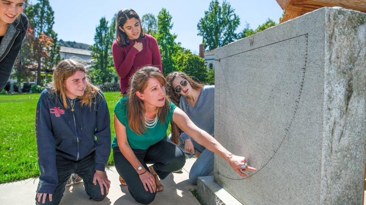 A professor demonstrating an angle on a plinth for students